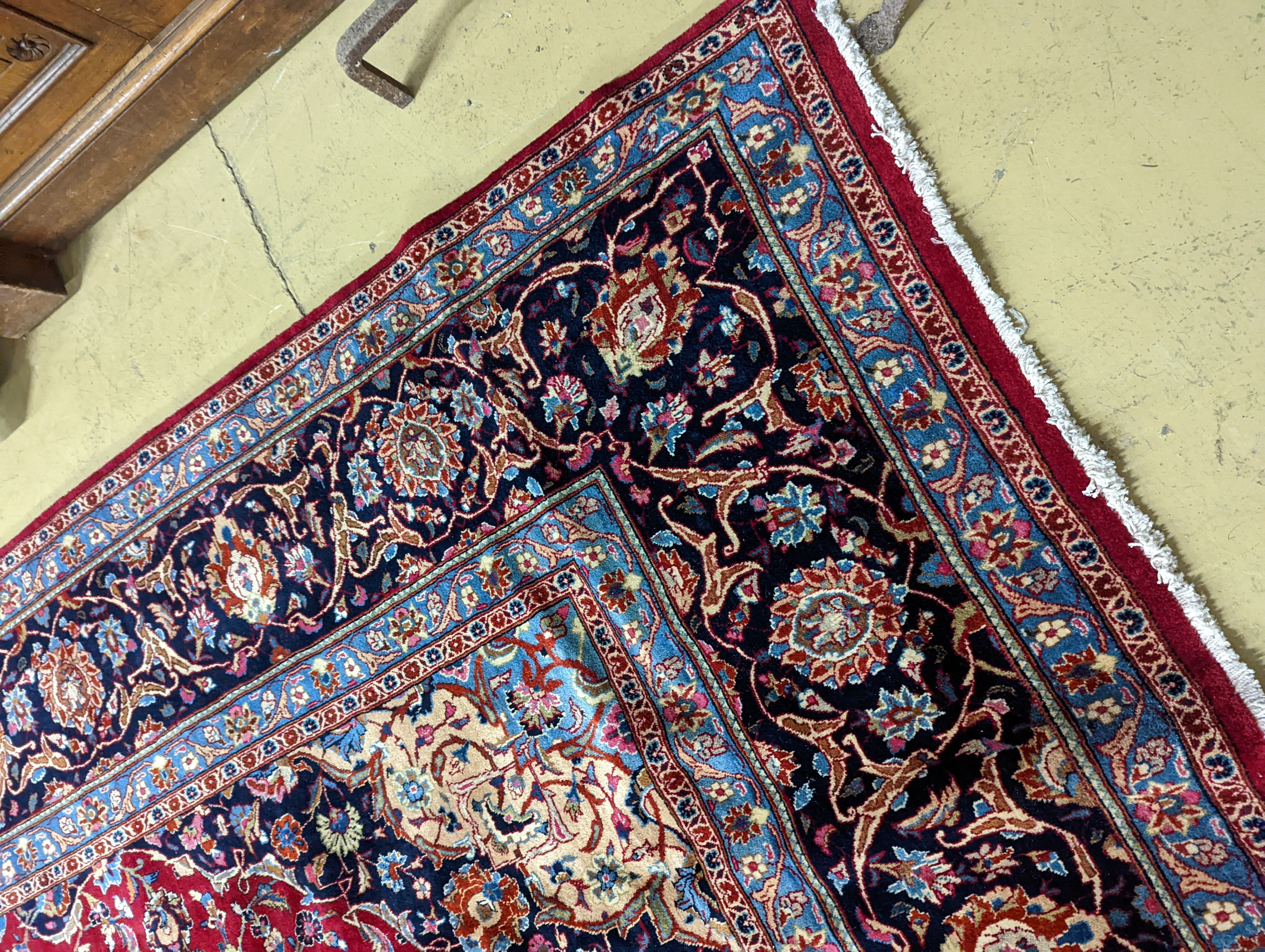 A Kashan burgundy ground carpet, 380 x 300cm